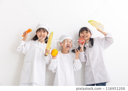 Children wearing school uniforms and holding vegetables Children wearing school uniforms and holding vegetables 116951208