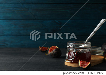 Figs and jar of jam on blue wooden background, space for text 116951977