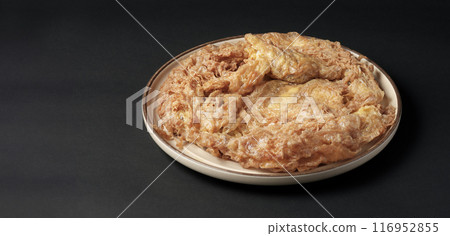 Thai-style pork omelette on black background with copy space. Thai-style pork omelette on black background with copy space. 116952855
