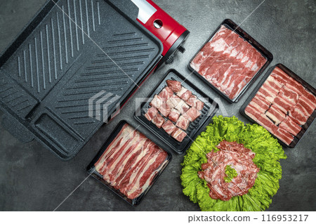 A variety of meats and vegetables are displayed on a counter A variety of meats and vegetables are displayed on a counter 116953217