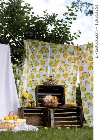 Basket of lemons. Decorations with lemons. Photo zone with citrus fruits Basket of lemons. Decorations with lemons. Photo zone with citrus fruits 116953253