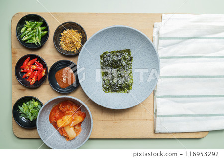 A wooden cutting board with a variety of bowls of food on it A wooden cutting board with a variety of bowls of food on it 116953292