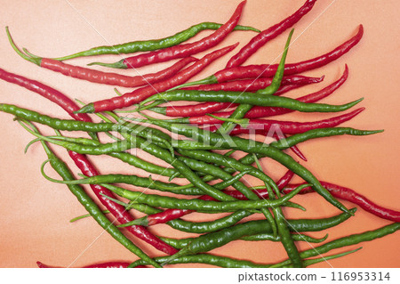 A bunch of green and red peppers are piled on top of each other 116953314