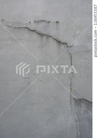 A grey wall with cracks and holes A grey wall with cracks and holes 116953387