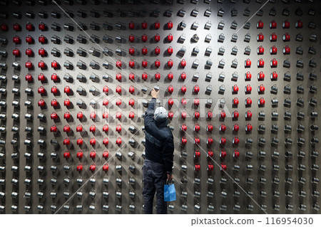 Chongqing, China, 6 March 2024, a customer grabing a metal cup from the wall Chongqing, China, 6 March 2024, a customer grabing a metal cup from the wall 116954030