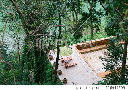 Swimming pool on cliff and green river Swimming pool on cliff and green river 116954209