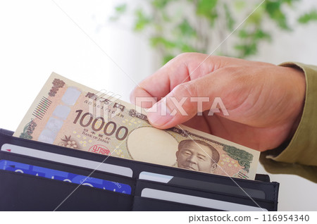 man taking money out of wallet man taking money out of wallet 116954340