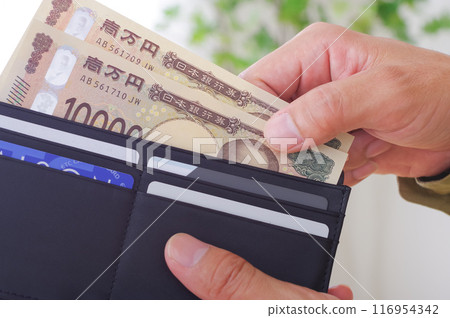man taking money out of wallet man taking money out of wallet 116954342