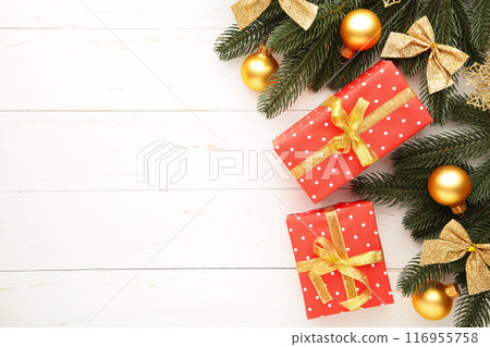 Christmas gift boxes and decorations on white wooden table. Christmas gift boxes and decorations on white wooden table. 116955758
