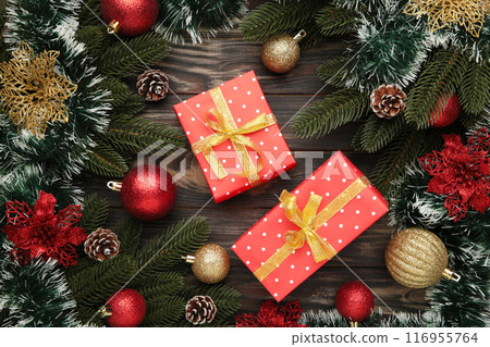 Christmas background with decorations and gift boxes on black wooden background. 116955764
