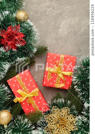 Christmas gift boxes and decorations on grey wooden table. 116956229