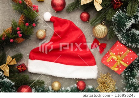 Christmas decorations with Santa hat on grey background. 116956243