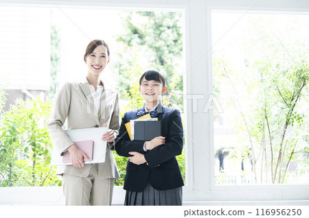 Teacher and student looking at camera portrait 116956250