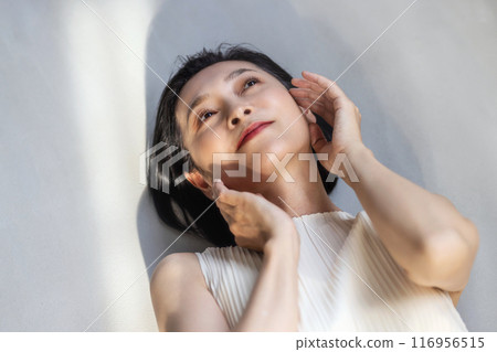 Middle-aged woman bathing in the sunset: beauty image 116956515