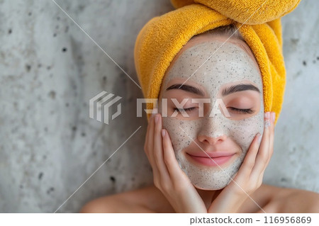 Beautiful young woman with facial mask in spa salon, closeup 116956869