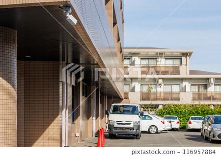 Security cameras installed at the entrance to the company building monitoring the parking lot 116957884