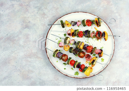 Grilled skewers vegetables on a plate. Grilled skewers vegetables on a plate. 116958465