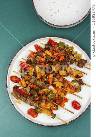 Grilled lamb kebab on skewers 116958479