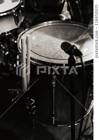 Concert Preparation. Drummer's seat, drum kit. Rock concert Drum kit close-up. vertical black and white photo. Concert Preparation. Drummer's seat, drum kit. Rock concert Drum kit close-up. vertical black and white photo. 116958935