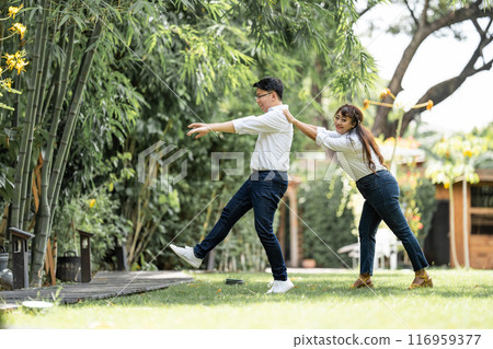 Asian Woman Grabbing and Catching Man shoulder and bracing the man to live with her. Asian Woman Grabbing and Catching Man shoulder and bracing the man to live with her. 116959377