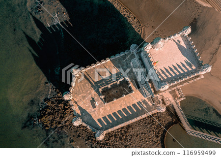 Top down or drone flat lay view of Belem tower, Lisbon, Portugal on sunny day. Medieval fort on Tagus river in late Gothic or Manueline style, UNESCO world heritage site, Age of Discoveries, tourist Top down or drone flat lay view of Belem tower, Lisbon, Portugal on sunny day. Medieval fort on Tagus river in late Gothic or Manueline style, UNESCO world heritage site, Age of Discoveries, tourist 116959499