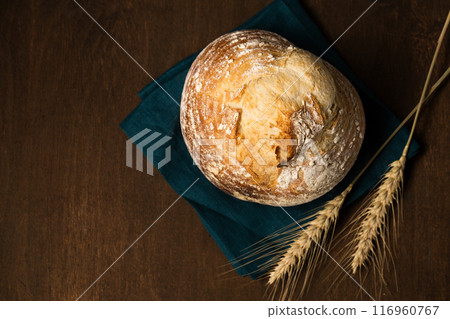 Delicious homemade unleavened bread in the shape of a volcano with an ear of wheat. Still life in a rustic style 116960767