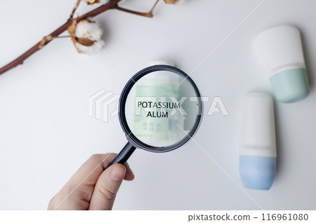 Potassium Alum in deodorant. Safe components and ingredients of cosmetics for care. Protection of armpits from sweating. Antiperspirants on the table, viewed under a magnifying glass 116961080