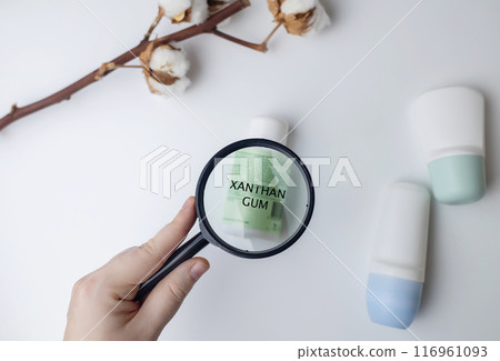 Xanthan Gum in deodorant. Safe components and ingredients of cosmetics for care. Protection of armpits from sweating. Antiperspirants on the table, viewed under a magnifying glass Xanthan Gum in deodorant. Safe components and ingredients of cosmetics for care. Protection of armpits from sweating. Antiperspirants on the table, viewed under a magnifying glass 116961093