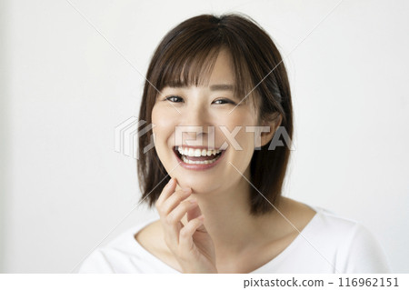 A woman in her 30s with a beautiful smile and straight teeth A woman in her 30s with a beautiful smile and straight teeth 116962151