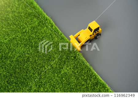 A bulldozer levels the area for construction, concept. Nature destruction of for technogenic development. Urbanization, increasing influence on environment. A bulldozer levels the area for construction, concept. Nature destruction of for technogenic development. Urbanization, increasing influence on environment. 116962349