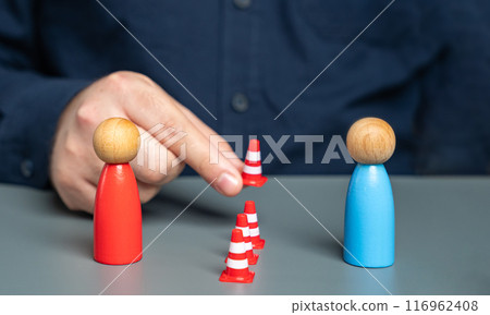 A man sets up a barrier of cones between people in conflict. Concept of the demarcation line. Freezing the conflict. Finding solutions. Reconciling the parties. Acting as a mediator. A man sets up a barrier of cones between people in conflict. Concept of the demarcation line. Freezing the conflict. Finding solutions. Reconciling the parties. Acting as a mediator. 116962408