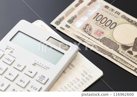 Calculator, bankbook and 10,000 yen note on a black background Calculator, bankbook and 10,000 yen note on a black background 116962600