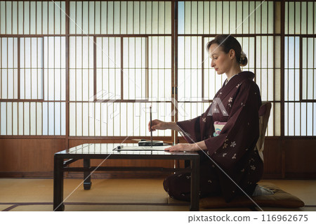 Foreign women doing calligraphy Foreign women doing calligraphy 116962675