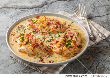 Pan-seared chicken in a creamy, spicy, street corn sauce with bacon closeup on the plate. Horizontal Pan-seared chicken in a creamy, spicy, street corn sauce with bacon closeup on the plate. Horizontal 116963687