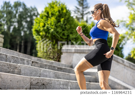 Young woman doing sports and running up the stairs Young woman doing sports and running up the stairs 116964231