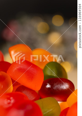 Christmas Gummy Colorful Candy on Garland Background. 116964564