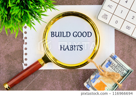 Healthy lifestyle and Healthy habits concept. Copy space. BUILD GOOD HABITS words through a magnifying glass on a piece of paper in a composition with banknotes, a plant and a calculator 116966694