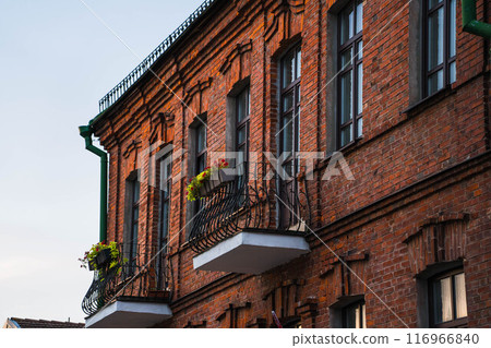 Balconies facing the street from an old, vintage, brick house Balconies facing the street from an old, vintage, brick house 116966840