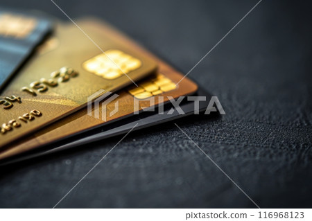Close-up view of several credit cards stacked on a black surface, copy space. Generative AI 116968123