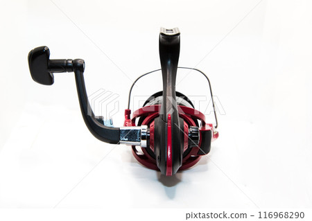 Red fishing reel for rod and spinning on white background Red fishing reel for rod and spinning on white background 116968290