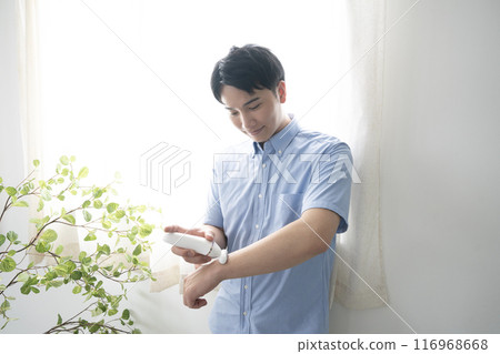 Young man depilating his arms Young man depilating his arms 116968668