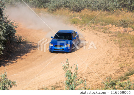 Rally Car on a Turn on a Dirt Road 116969005
