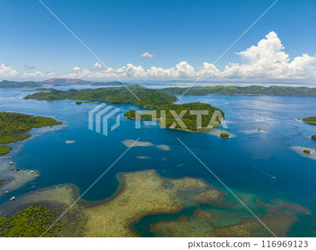 Tinago Island with blue sea. Beautiful blue sky and clouds. Mindanao, Philippines. Aerial drone view: Travel concept. 116969123