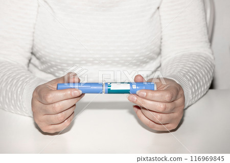 Female hands holding an insulin pen. Ozempic Insulin injection pen. 116969845
