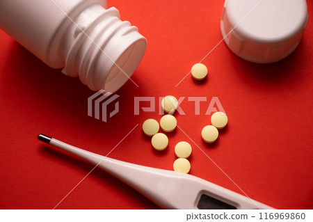 medicine bottle and pills on red background. medicine bottle and pills on red background. 116969860