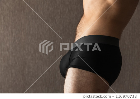 Belly and hips of a young sporty man in black boxer underpants Belly and hips of a young sporty man in black boxer underpants 116970738