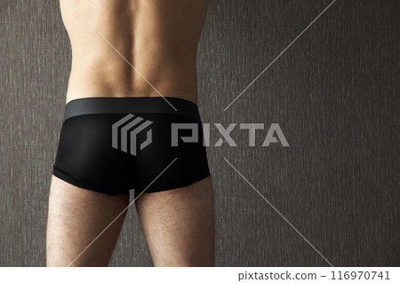 Black male underpants boxer are worn on a young sporty man Black male underpants boxer are worn on a young sporty man 116970741