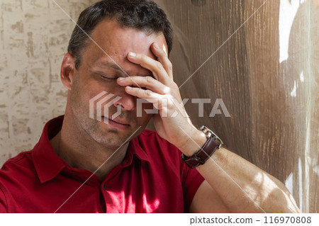 Stressed young adult Caucasian man, studio photo 116970808