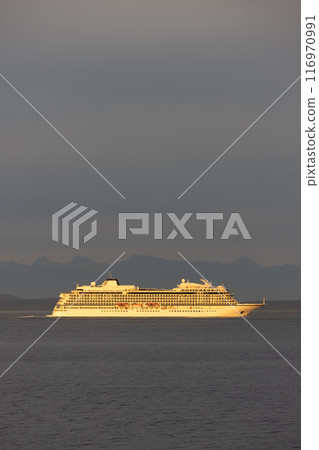 Cruise ship sailing at sunset 116970991