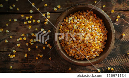 Bowl with corn seeds and ripe corn cobs on wooden table 116971184